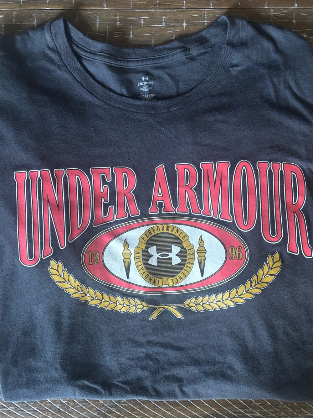 Under Armour Black Tee with Red and Gold Crest Graphic